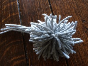 Cut ends on pom-pom ready to shape for stocking toe