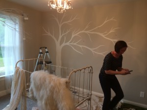 Sarah painting tree mural