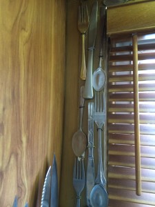 silverware attached to window frame in kitchen