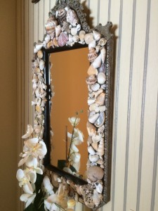 colored shell mirror on bath wall