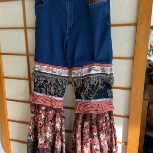 Upcycled jeans have a boho, late 60's hippie vibe size 10