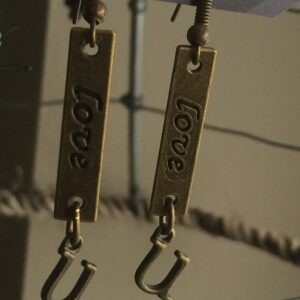 “Love U” dangle handmade for pierced ears in an antique bronze color metal.